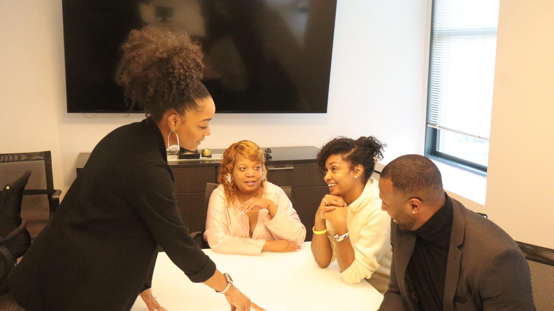 Group of black professionals engaging in a discussion in a conference room