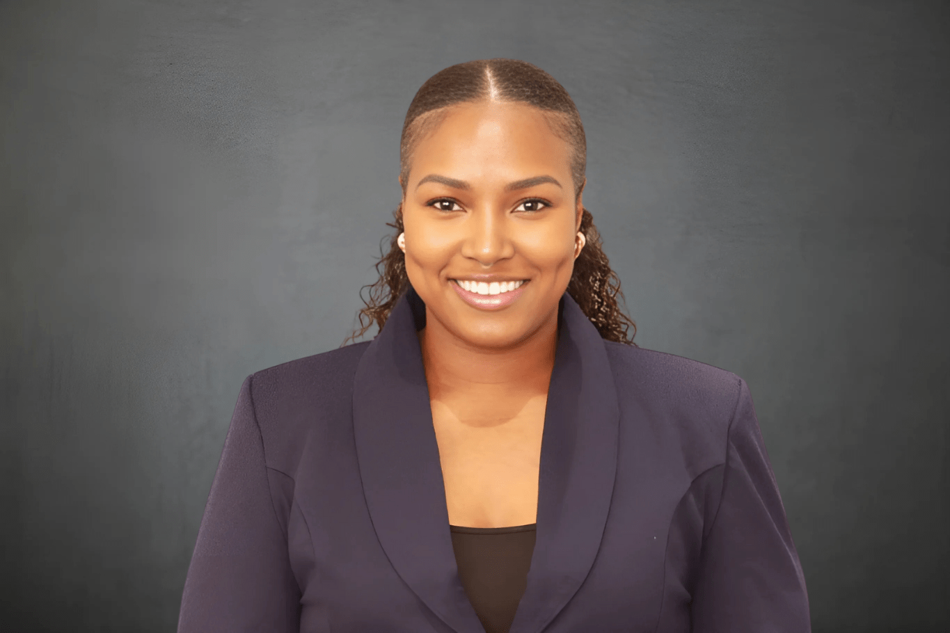Young black woman dressed professionally and smiling
