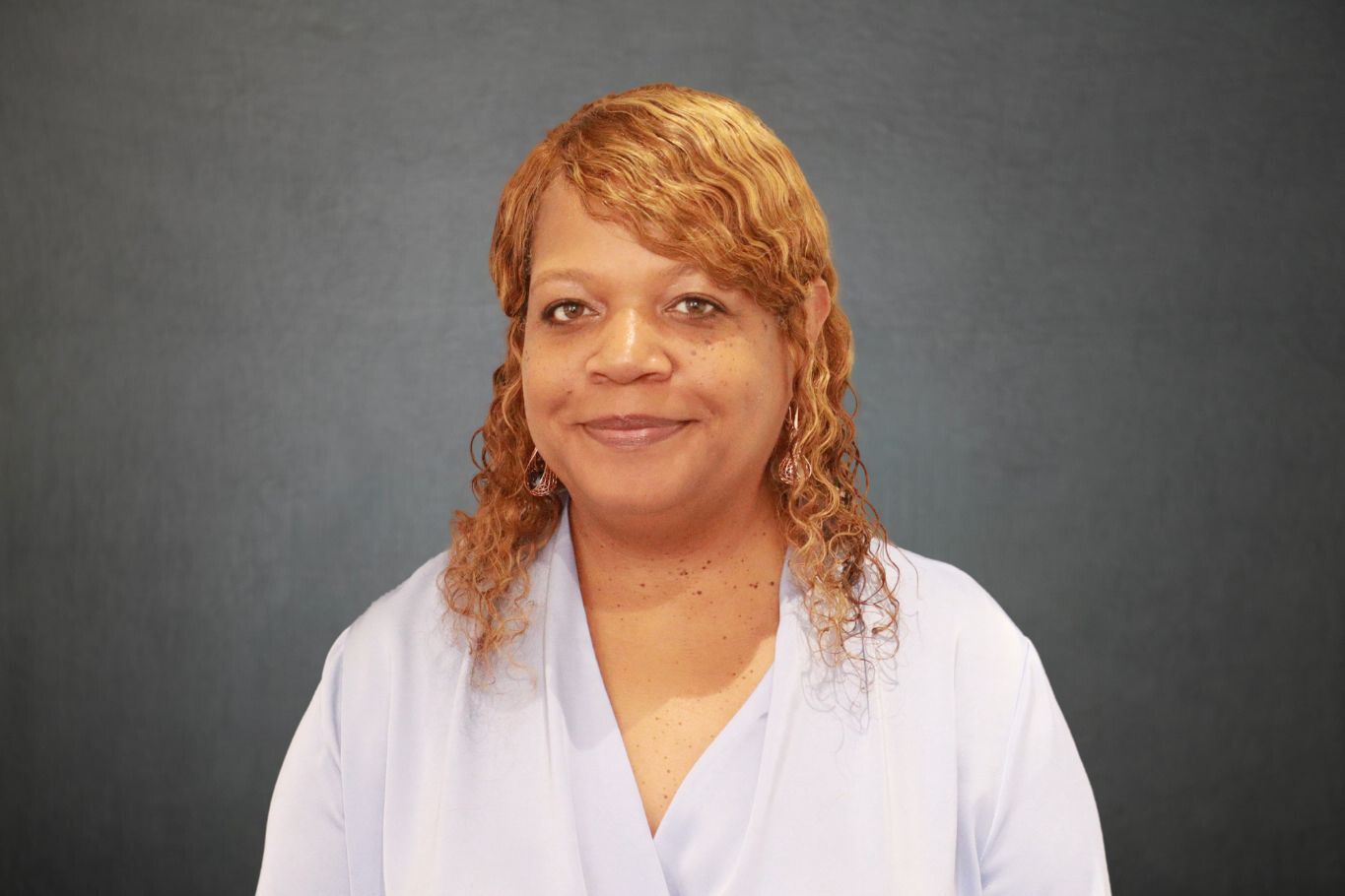 Black woman dressed professionally for a headshot